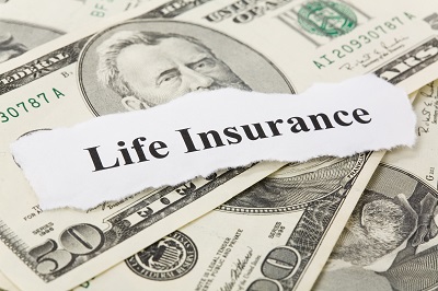 image of life insurance sign on money