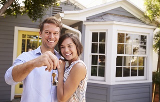 image of couple in front of new house