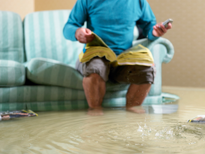 person sitting in flood water