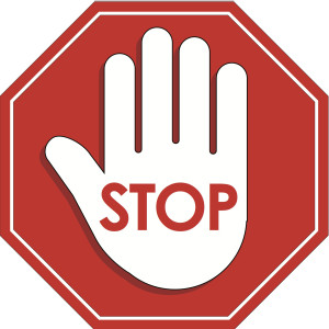 red stop sign with hand in the middle